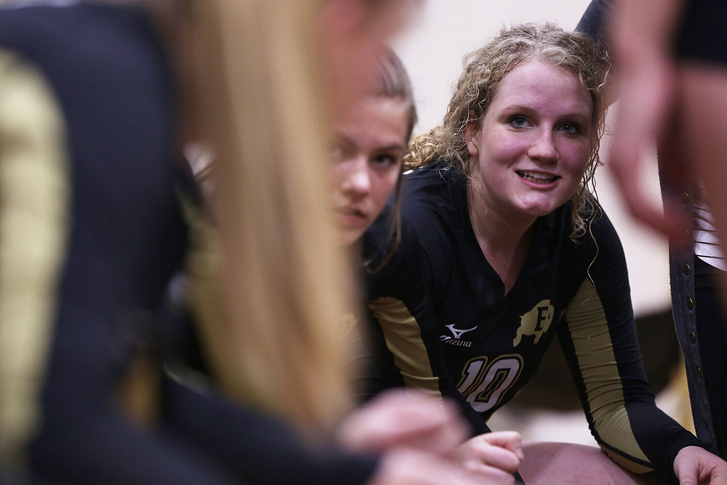Tessa Taylor laughs with the team during their huddle